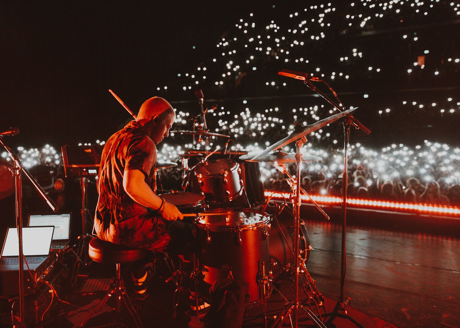 Playing drums to a full arena lit by phone lights
